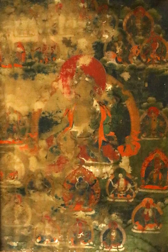 A thangka depicting Green Tara, Tibet, 19th century 67cm x 45cm, worn
